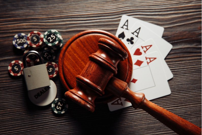 Gavel with poker chips and playing cards